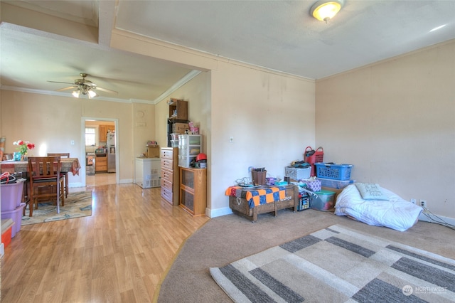 interior space with wood-type flooring, ornamental molding, stainless steel fridge with ice dispenser, and ceiling fan