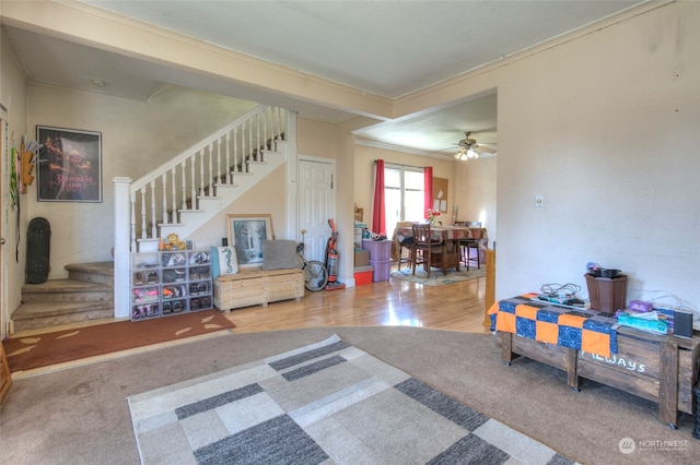 interior space featuring ceiling fan, hardwood / wood-style flooring, and crown molding