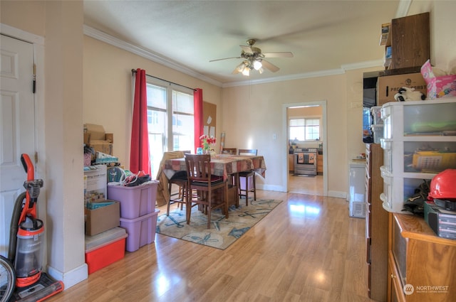 dining area featuring ceiling fan, ornamental molding, plenty of natural light, and light hardwood / wood-style floors