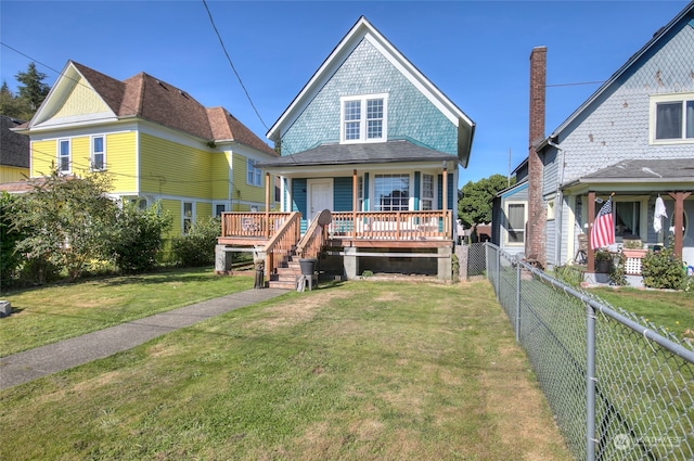 view of front of house with a front yard and covered porch