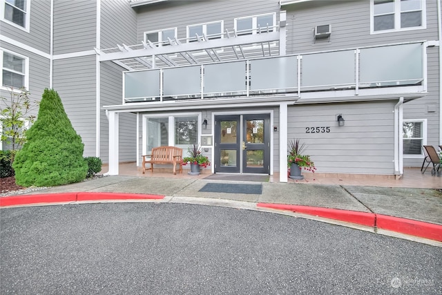 entrance to property with french doors and a balcony