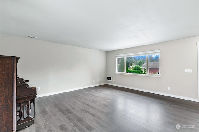 empty room with hardwood / wood-style flooring