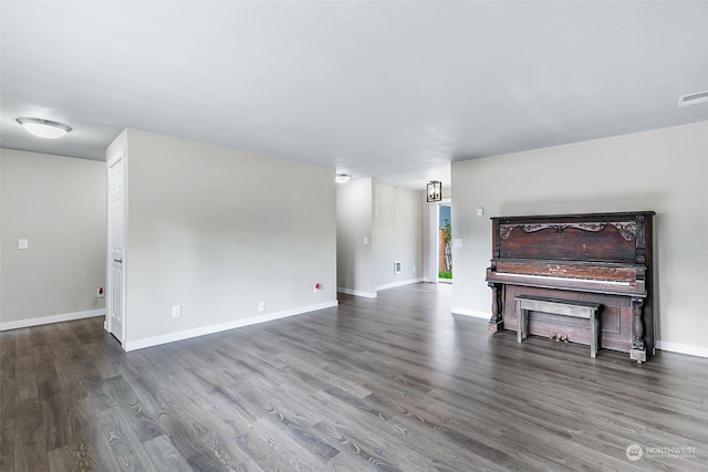 unfurnished living room with dark hardwood / wood-style floors