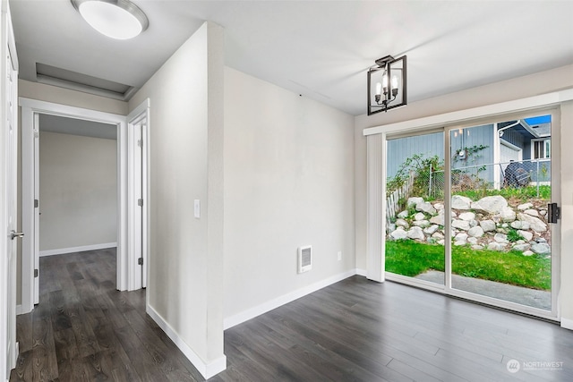 unfurnished dining area featuring dark hardwood / wood-style floors and a notable chandelier