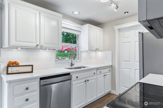 kitchen featuring appliances with stainless steel finishes, sink, and white cabinetry