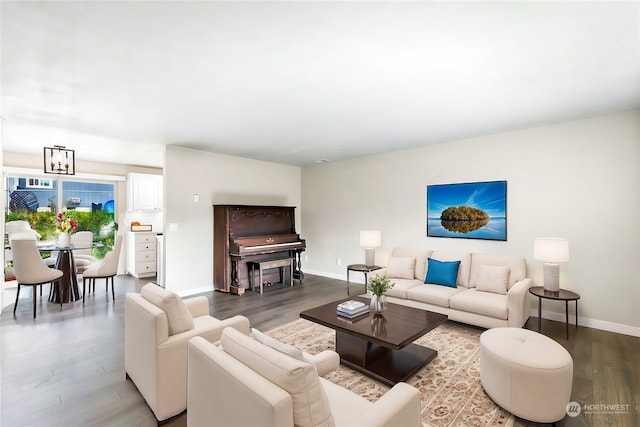 living room featuring an inviting chandelier and hardwood / wood-style floors