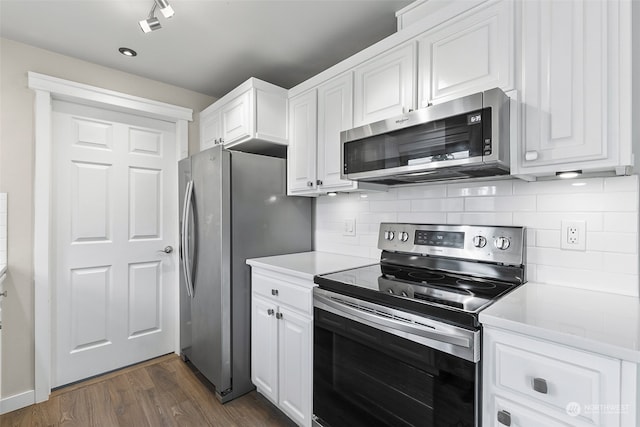 kitchen with stainless steel appliances, dark hardwood / wood-style flooring, decorative backsplash, and white cabinetry