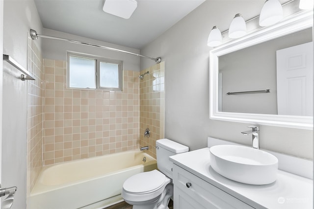 full bathroom with vanity, tiled shower / bath combo, and toilet