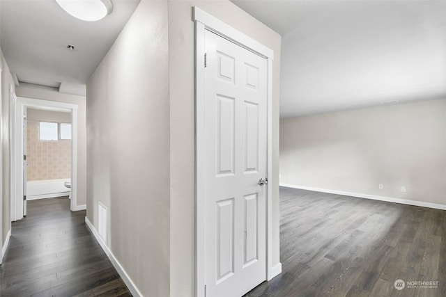 hall with dark wood-type flooring