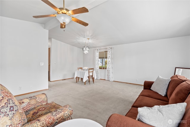 living room featuring ceiling fan with notable chandelier and light carpet