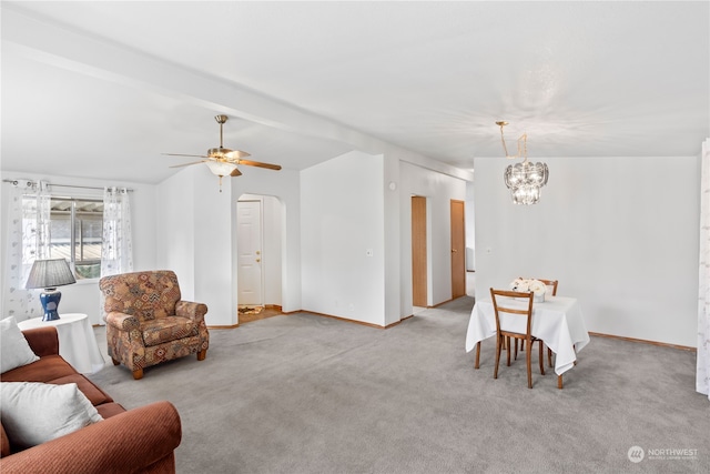 dining room featuring ceiling fan with notable chandelier and light carpet