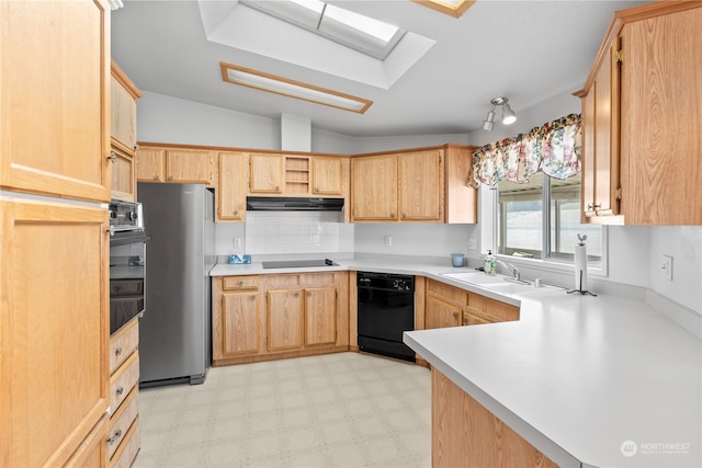 kitchen featuring vaulted ceiling with skylight, sink, kitchen peninsula, black appliances, and light brown cabinets