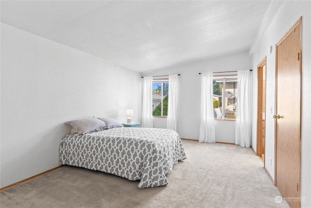 carpeted bedroom featuring vaulted ceiling