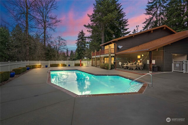 pool at dusk with a patio