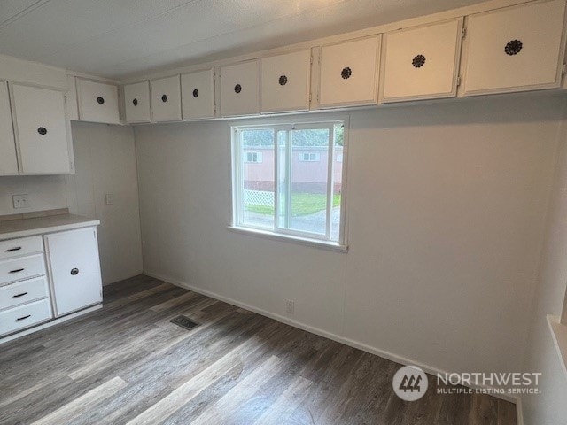 kitchen featuring white cabinetry and hardwood / wood-style floors