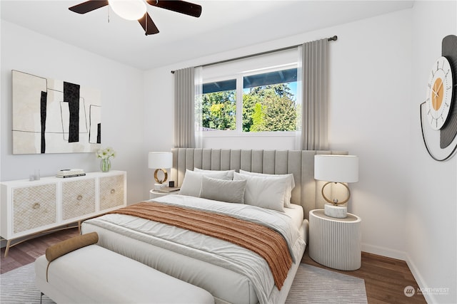 bedroom with dark hardwood / wood-style floors and ceiling fan