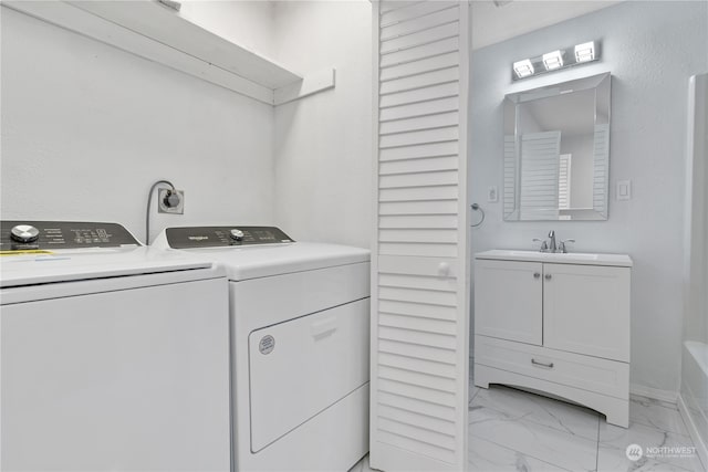 washroom with washer and clothes dryer and sink