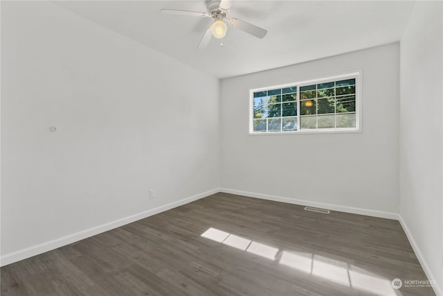 empty room featuring dark hardwood / wood-style flooring and ceiling fan