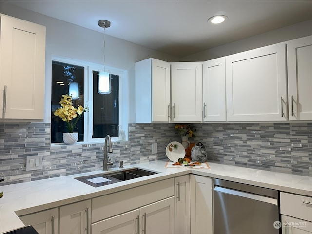 kitchen with decorative backsplash, stainless steel dishwasher, sink, and white cabinets