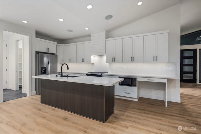 kitchen featuring backsplash, sink, white cabinets, and stainless steel appliances