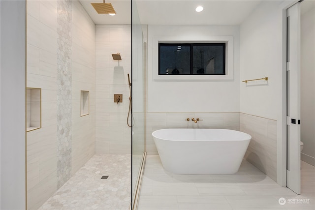 bathroom featuring plus walk in shower and tile patterned floors