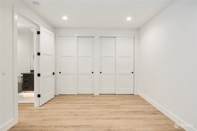 interior space featuring two closets and light wood-type flooring