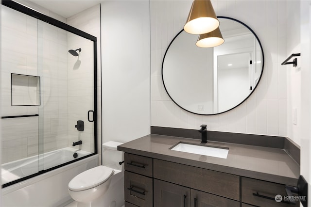 full bathroom with vanity, toilet, and bath / shower combo with glass door