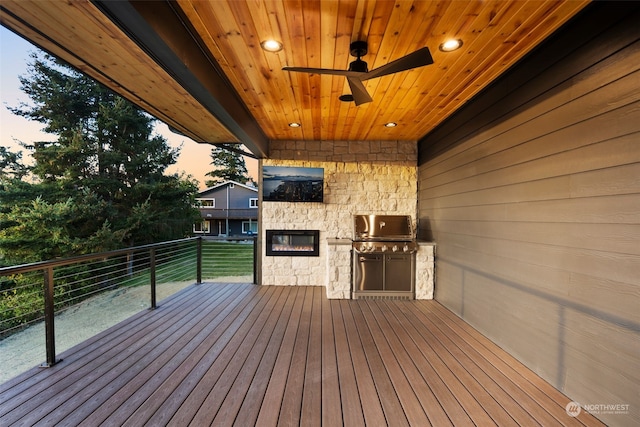 deck with an outdoor kitchen and ceiling fan