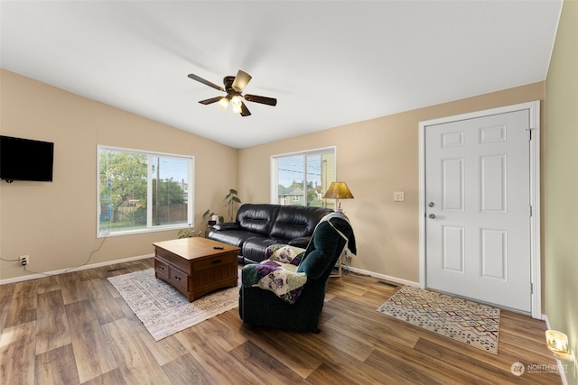 living room featuring wood-type flooring, vaulted ceiling, and ceiling fan