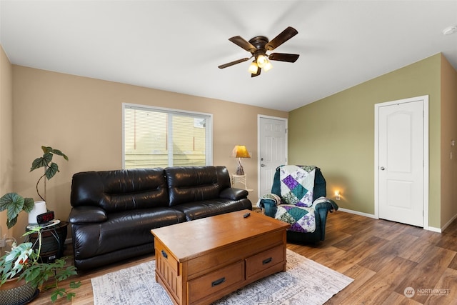 living room with ceiling fan, lofted ceiling, and dark hardwood / wood-style floors