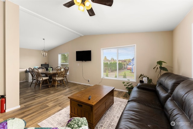 living room featuring vaulted ceiling with beams, ceiling fan, and hardwood / wood-style flooring