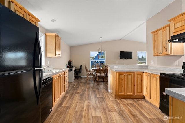 kitchen featuring light wood-type flooring, vaulted ceiling, kitchen peninsula, hanging light fixtures, and black appliances