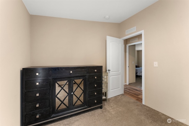 unfurnished bedroom with light colored carpet