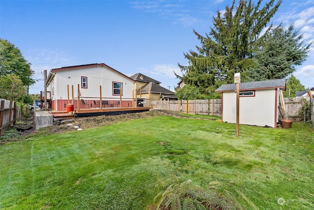 view of yard featuring a storage unit and a wooden deck