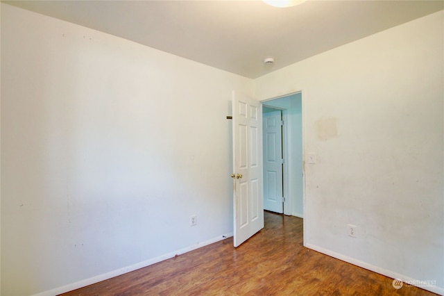 spare room featuring wood-type flooring