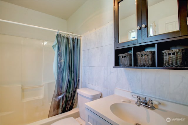 full bathroom with tile walls, shower / tub combo with curtain, vanity, and toilet