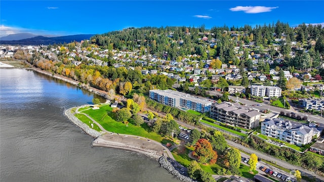 birds eye view of property with a water and mountain view