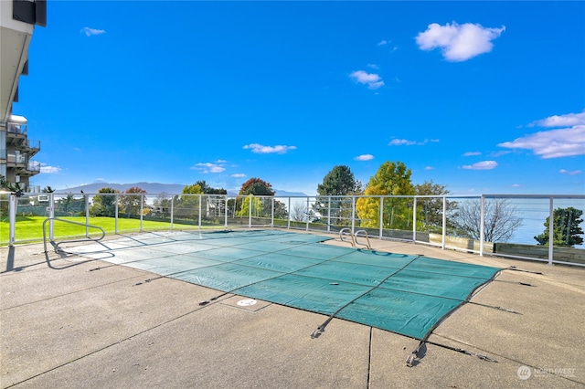 view of pool featuring a mountain view and a patio