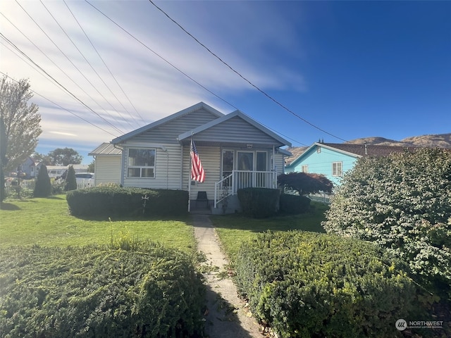 bungalow-style home featuring a front lawn