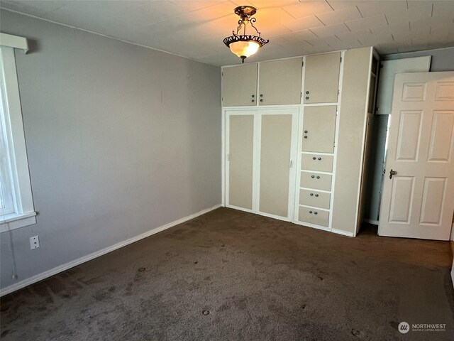 interior space featuring baseboards and carpet flooring