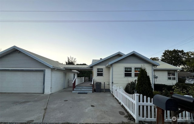 ranch-style home featuring fence and a wooden deck