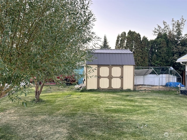 view of outdoor structure featuring a lawn