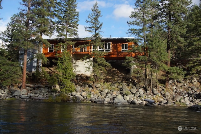 back of property with a water view