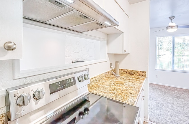 kitchen with stainless steel range oven, white cabinets, light carpet, exhaust hood, and ceiling fan