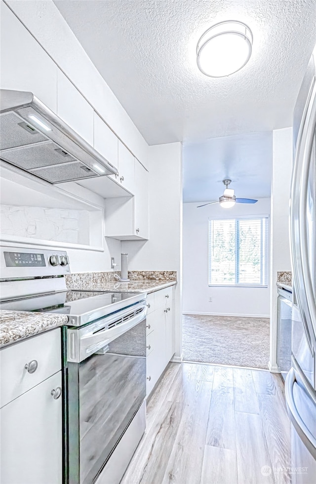 kitchen with ceiling fan, white cabinets, light hardwood / wood-style flooring, ventilation hood, and stainless steel appliances