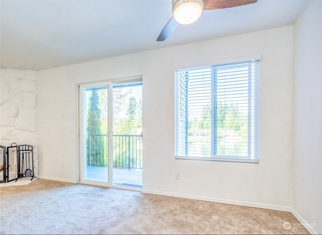 carpeted spare room featuring ceiling fan