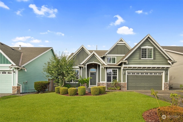 1925 32nd Avenue Ct SW, Puyallup, WA 98373 - craftsman-style house with board and batten siding, a garage, stone siding, a front lawn, and driveway