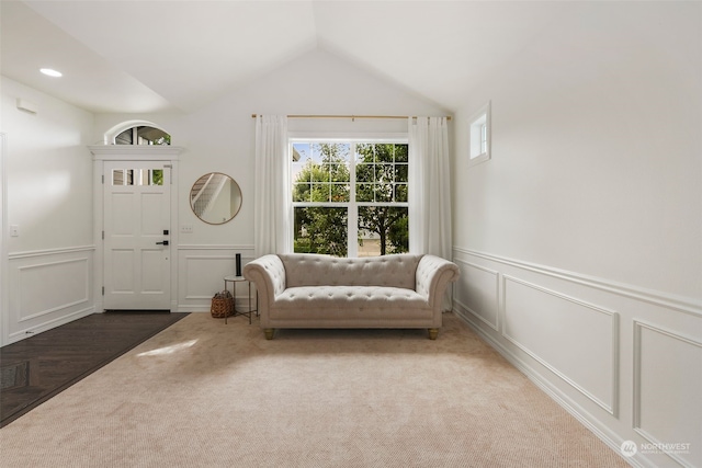 entrance foyer featuring carpet floors and lofted ceiling