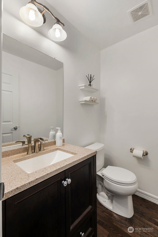 bathroom featuring hardwood / wood-style floors, vanity, and toilet