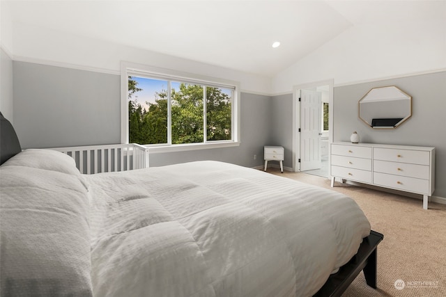 bedroom featuring light colored carpet and lofted ceiling